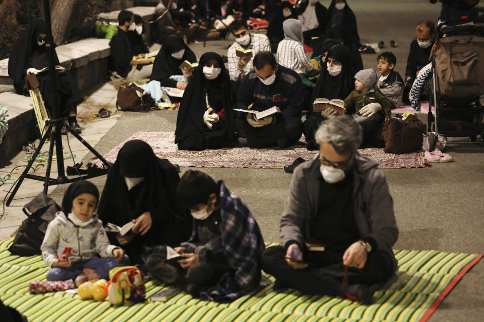 Worshippers wearing protective face masks to help prevent the spread of the coronavirus pray outside the mosque of the Tehran University in Laylat al-Qadr, or the night of destiny, during holy fasting month of Ramadan, Iran, Tuesday, May 12, 2020. On Tuesday authorities allowed mosques temporarily reopen for limited hours up to two hours, while strictly observing health and social procedures to prevent spreading the disease. (AP Photo/Vahid Salemi)