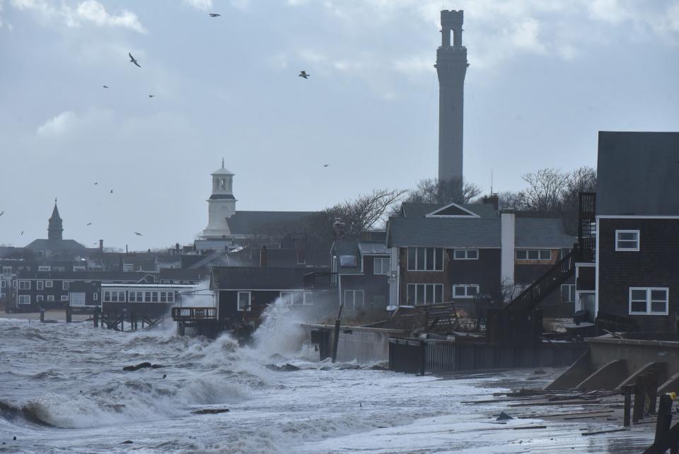 Chris Wilcox documents the damage from a seawall in the east end of Provincetown, which was hard hit by the morning high tide and high winds from Winter Storm Elliott.