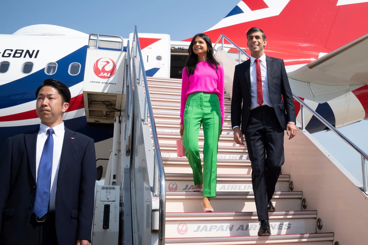 British Prime Minister Rishi Sunak, center right, and his wife Akshata Murty disembark their plane as they arrive at the airport, in Tokyo, Japan, ahead of the G-7 Summit (AP)