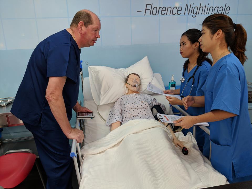 Nursing students Sahrulniza Abdul Ghani (middle) and Lim Ai Min (right) in the midst of a hands-on practice session at the official opening of MDIS’ Nursing Practicum Lab on 21 May, 2018. (PHOTO: Wong Casandra/Yahoo News Singapore)