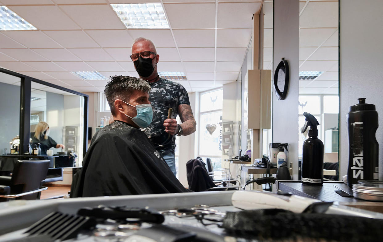 Image: A customer has his hair cut at a hairdresser in Kobavogur, Iceland (Halldor Kolbeins / AFP - Getty Images)