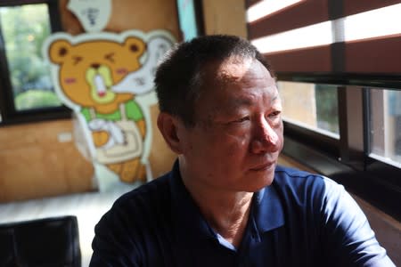 Lin Guo-cing, a senior official of the Chinese Unity Promotion Party, sits at a cafe at a theme park he is planning to introduce to the China market, in Chiayi