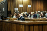 Oscar Pistorius in the dock in court in Pretoria, South Africa, Wednesday, May 14, 2014, as the judge overseeing his murder trial ordered him to undergo psychiatric tests. The court adjourned until May 21, 2014. (AP Photo/Gianluigi Guercia - Pool)