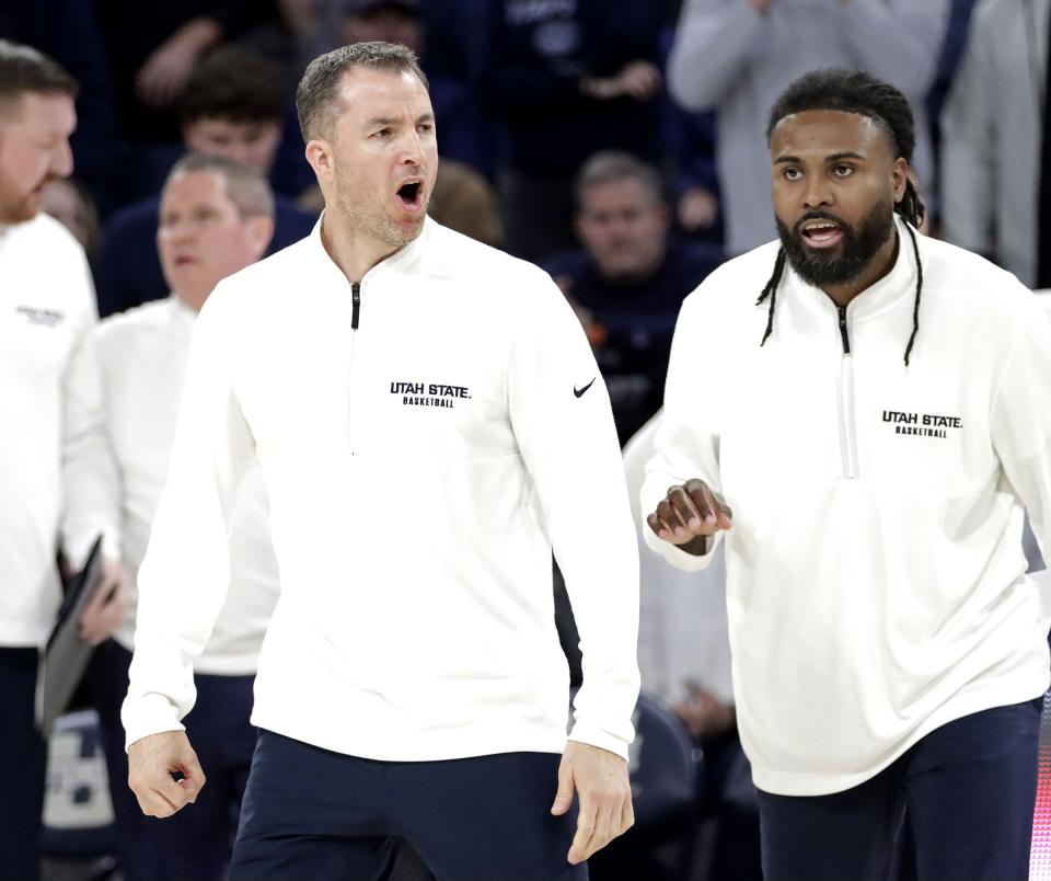 Utah State head coach Danny Sprinkle, left, voices his opinion of a call as assistant coach Johnny Hill closes in during USU’s win over No. 13 Colorado State Jan. 6 at the Spectrum in Logan. | Jeff Hunter