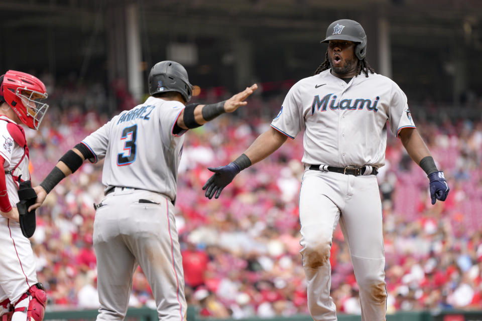 Miami Marlins' Josh Bell, right, celebrates with Luis Arraez (3) after hitting a two-run home run during the eighth inning of a baseball game against the Cincinnati Reds Wednesday, Aug. 9, 2023, in Cincinnati. (AP Photo/Jeff Dean)