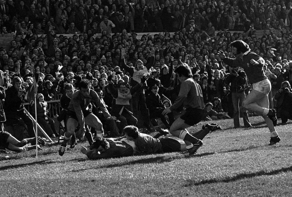 Phil Bennett (right, on the ground) scores a try for Wales against France in the Five Nations (PA). (PA Archive)