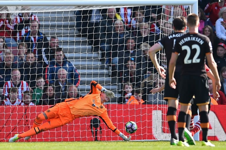 Hull City's goalkeeper Eldin Jakupovic dives to save the penalty kick taken by Southampton's Dusan Tadic during their English Premier League football match at St Mary's Stadium in Southampton, southern England on April 29, 2017