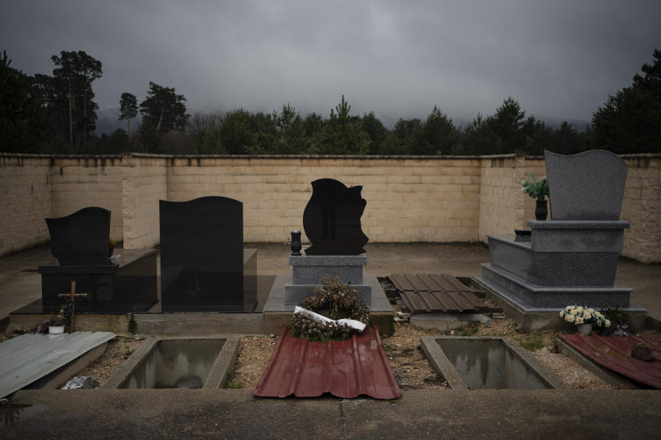 In this April 28, 2020 photo, graves of the recently deceased are temporarily covered by metal sheets in the cemetery in Duruelo de la Sierra, Spain, in the province of Soria. Many in Spain's small and shrinking villages thought their low populations would protect them from the coronavirus pandemic. The opposite appears to have proved true. Soria, a north-central province that's one of the least densely peopled places in Europe, has recorded a shocking death rate. Provincial authorities calculate that at least 500 people have died since the start of the outbreak in April. (AP Photo/Felipe Dana)