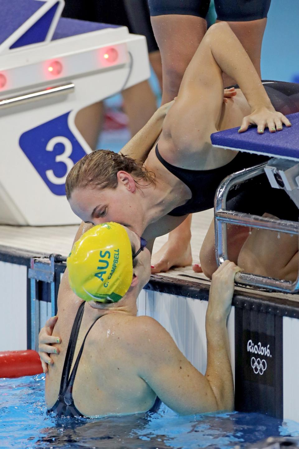 <p>Bronte Campbell, top, Australia, kisses her sister Cate Campbell, after the Australian team won the Women’s 4 x 100m Freestyle Relay Final in world record time during the swimming competition at the Olympic Aquatics Stadium August 6, 2016 in Rio de Janeiro, Brazil. (Photo by Tim Clayton/Corbis via Getty Images) </p>