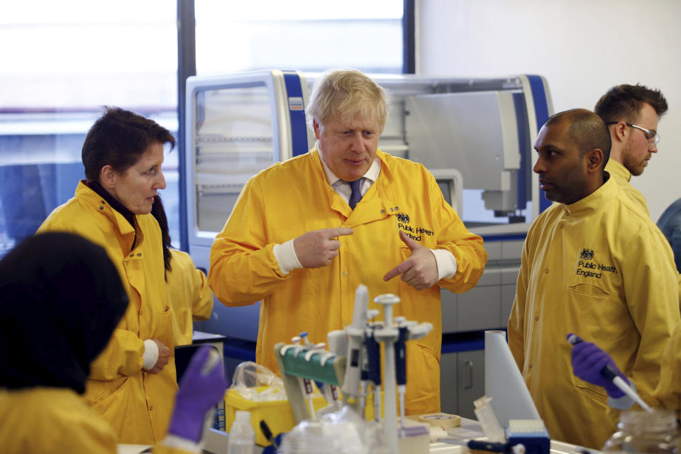 Britain's Prime Minister Boris Johnson visits a laboratory at the Public Health England National Infection Service, after more than 10 new coronavirus patients were identified in England, in Colindale, north London, Sunday, March 1, 2020. (Henry Nicholls/Pool Photo via AP)