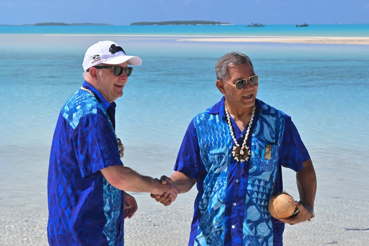 Australia’s Prime Minister Anthony Albanese, left, and Tuvalu’s Prime Minister Kausea shake hands on One Foot Island after attending the Leaders’ Retreat during the Pacific Islands Forum in Aitutaki, Cook Islands (AP)