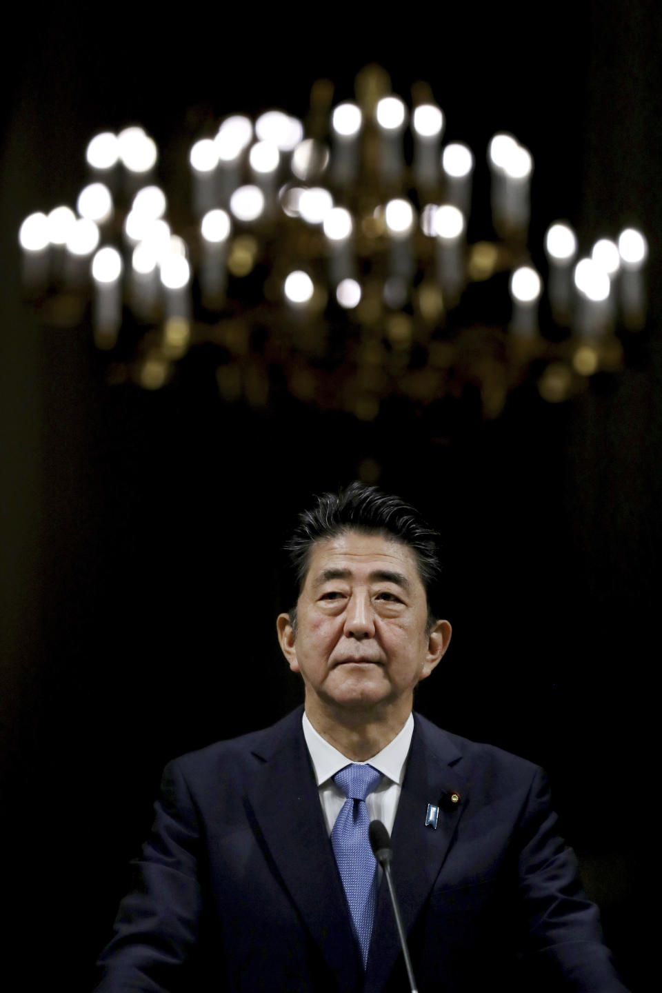 Japanese Prime Minister Shinzo Abe listens during a joint press conference with Iranian President Hassan Rouhani after their meeting at the Saadabad Palace in Tehran, Iran, Wednesday, June 12, 2019. The Japanese leader is in Tehran on an mission to calm tensions between the U.S. and Iran. (AP Photo/Ebrahim Noroozi)