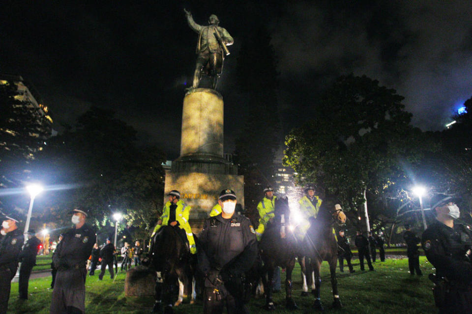 In Sydney over the weekend, police stood guard around a statue of Captain Cook in Hyde Park, in fear it would be vandalised as part of the Black Lives Matter protests. Photo: Getty