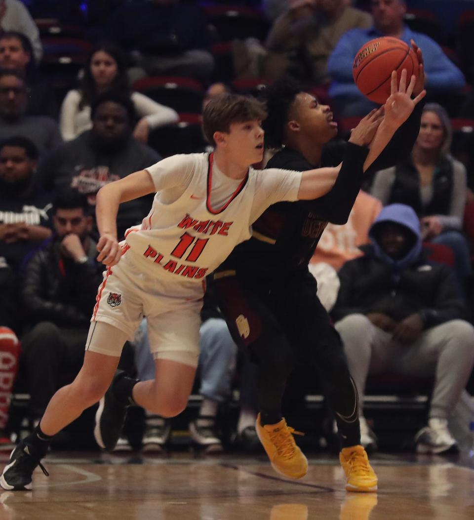 White Plains Nick Triolo (11) puts pressure Mt. Vernon's Dwight Findlay (23) during the Section 1 Class AAA semifinal at the Westchester County Center in White Plains Feb. 28, 2024.