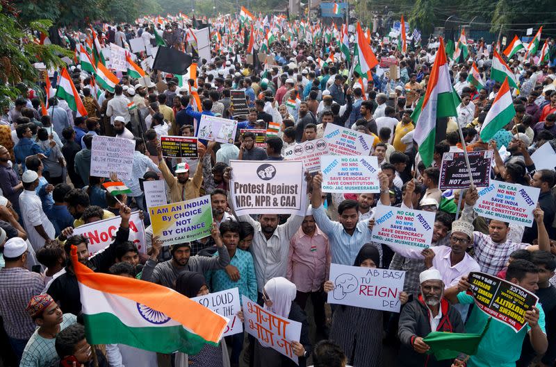 Demonstrators hold placards and flags as they attend a protest rally against a new citizenship law, in Hyderabad