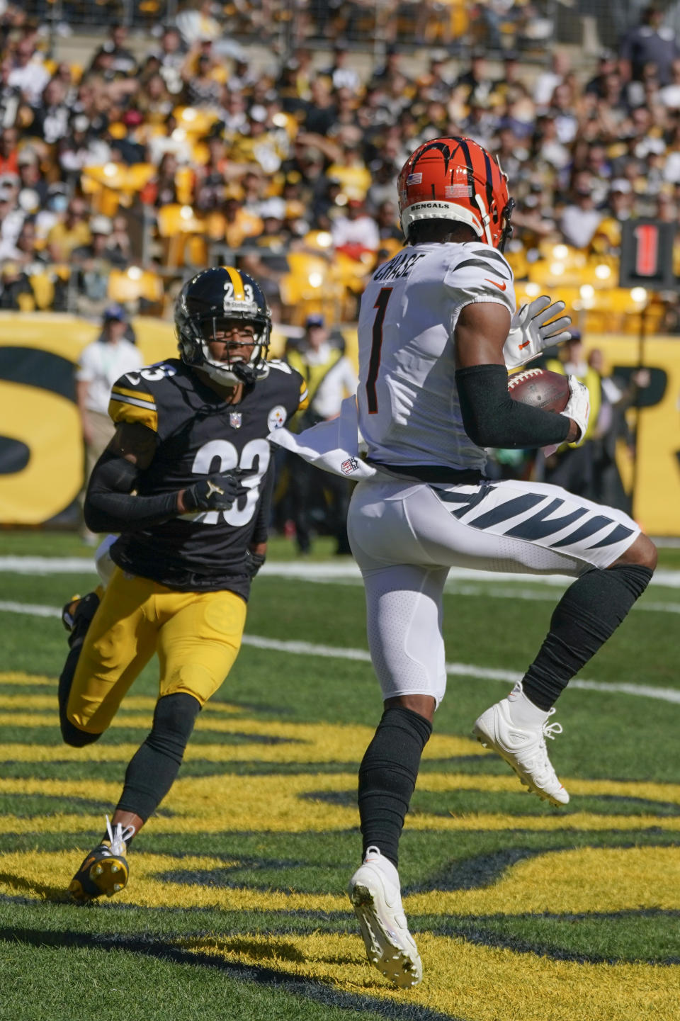 Cincinnati Bengals wide receiver Ja'Marr Chase (1) catches a touchdown pass in front of Pittsburgh Steelers cornerback Joe Haden (23) during the second half an NFL football game, Sunday, Sept. 26, 2021, in Pittsburgh. (AP Photo/Gene J. Puskar)
