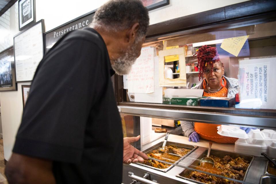 Former Metro Council member Ludye Wallace asks Sophia Turner, third generation owner of Silver Sands Cafe for pig’s feet, while Turner suggests grilled chicken instead due to his health, in Nashville, Tenn., Tuesday, Sept. 26, 2023.