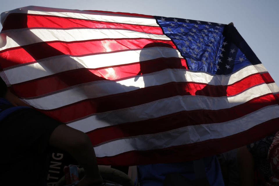 Pro-immigration activist holds an American flag