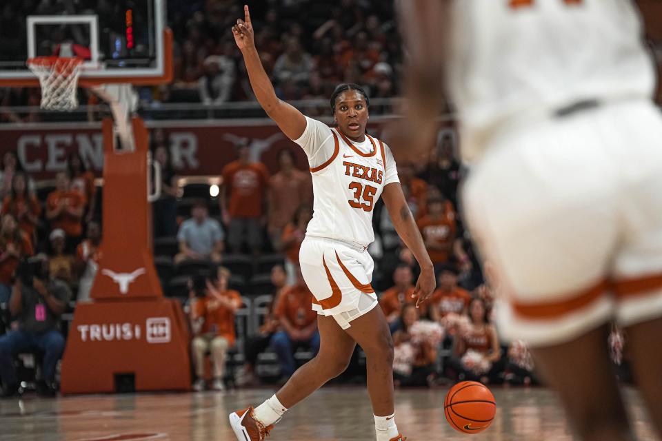 Longhorns guard Madison Booker directs her teammates during the victory. Booker played all 40 minutes and finished with 20 points and four assists.