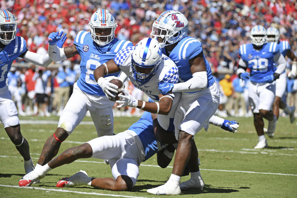 Kentucky tight end Jordan Dingle (85) dives for a touchdown past Mississippi safeties Otis Reese (3), Isheem Young (1) and linebacker Troy Brown (8) during the second half of an NCAA college football game in Oxford, Miss., Saturday, Oct. 1, 2022. Mississippi won 22-19. (AP Photo/Thomas Graning)