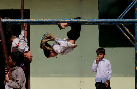 Children play on the monkey bars at the Mashal Model school in Islamabad, Pakistan, September 26, 2017. REUTERS/Caren Firouz