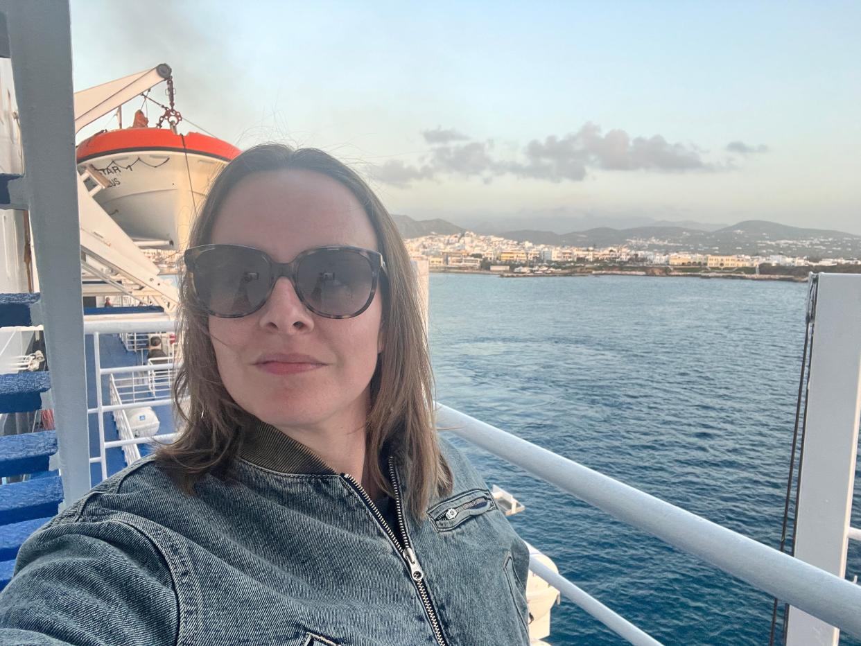 katie posing for a selfie on the deck of a ferry in greece