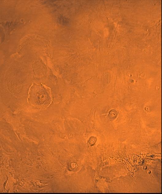 A Viking picture of the Tharsis volcanic region of Mars. At left is Olympus Mons. The chain of volcanoes at lower right, from bottom to top, is Arsia, Pavonis, and Ascraeus Mons.