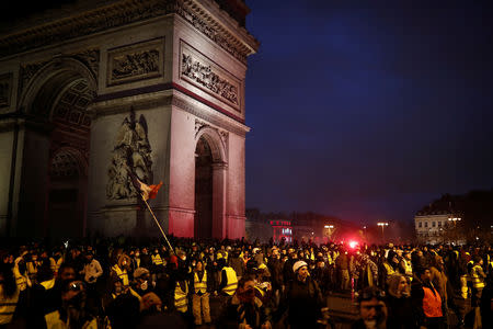 Protesters wearing yellow vests, a symbol of a French drivers' protest against higher diesel taxes, gather at the Place de l'Etoile near the Arc de Triomphe in Paris, France, December 1, 2018. REUTERS/Benoit Tessier