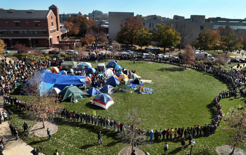 University of Missouri students circle tents on the Carnahan Quadrangle, locking arms to prevent media from entering the space following the resignation of President Timothy W. Wolfe on Monday, Nov. 9, 2015. (Robert Cohen/St. Louis Post-Dispatch/TNS via Getty Images)