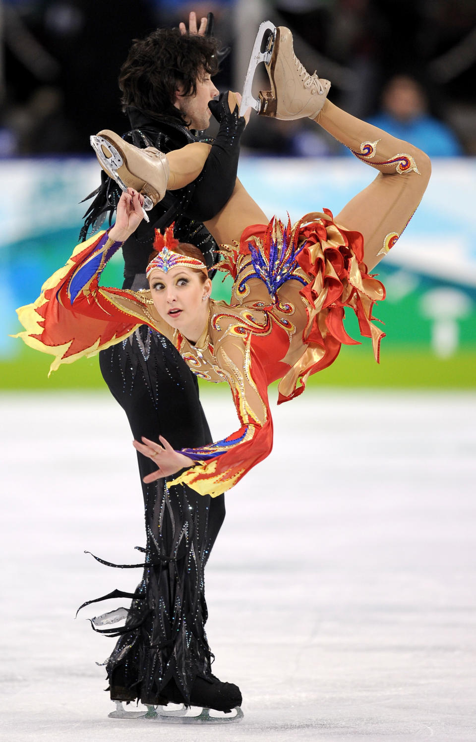 <p>The original girl on fire, Jana Khokhlova went orange and blue with her competition outfit as well as cutouts all over. Her head band also had gems and red and yellow feathers to complete the outfit. </p>