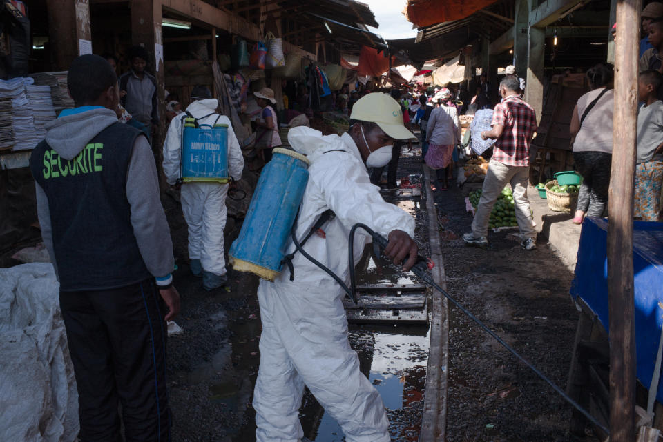 Government&nbsp;workers spray disinfectant during&nbsp;cleanup of&nbsp;a market&nbsp;in Antananarivo, the capital of Madagascar, on Oct. 10. (Photo: RIJASOLO/AFP via Getty Images)