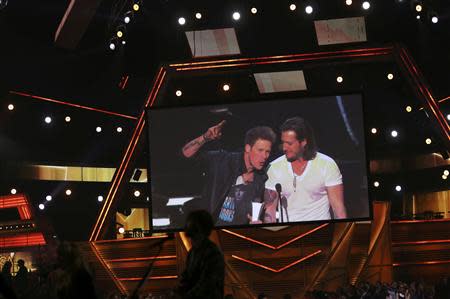 Brian Kelley (L) and Tyler Hubbard of Florida Georgia Line accept the Vocal Duo of the Year Award at the 49th Annual Academy of Country Music Awards in Las Vegas, Nevada April 6, 2014. REUTERS/ Robert Galbriath
