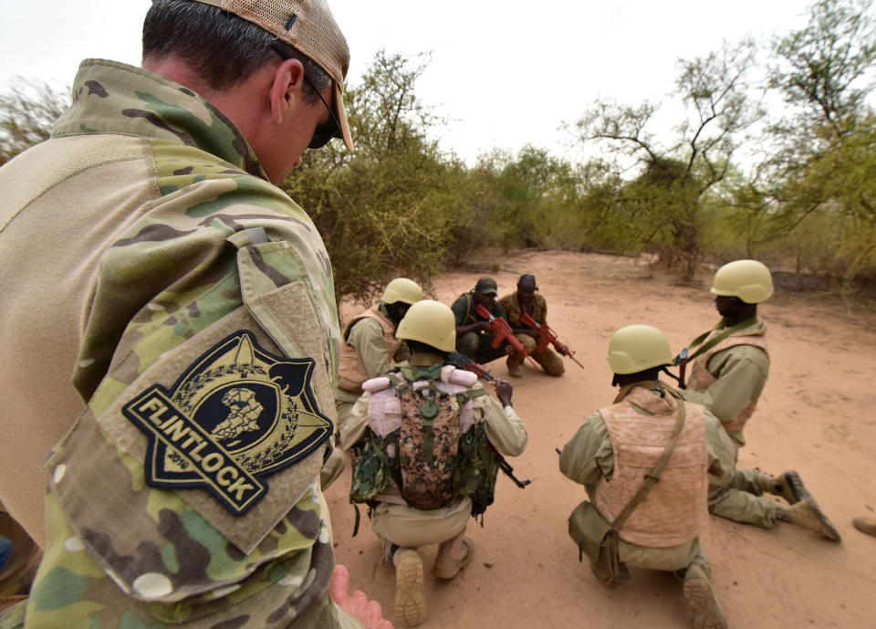 An arm patch for the Exercise Flintlock 2018 is seen on the shirt of an Austrian army instructor training soldiers from Burkina Faso at the Kamboinse - General Bila Zagre military camp near Ouagadougo in Burkina Faso on April 13, 2018.Some 1,500 African, American and European troops began maneuvers in Burkina Faso, western and northern Niger on April 12 to exercise against the terrorist threats hovering over these regions. / AFP PHOTO / ISSOUF SANOGO (Photo credit should read ISSOUF SANOGO/AFP via Getty Images)