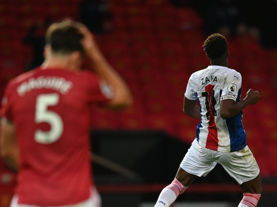 Wilfried Zaha celebrates scoring against his former side Manchester United (POOL/AFP via Getty Images)