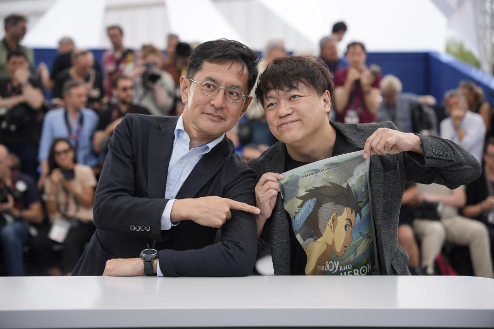 Goro Miyazaki, left, and Kenichi Yoda pose for photographers at the Studio Ghibli honorary Palme d'Or photo call at the 77th international film festival, Cannes, southern France, Monday, May 20, 2024. (Photo by Andreea Alexandru/Invision/AP)