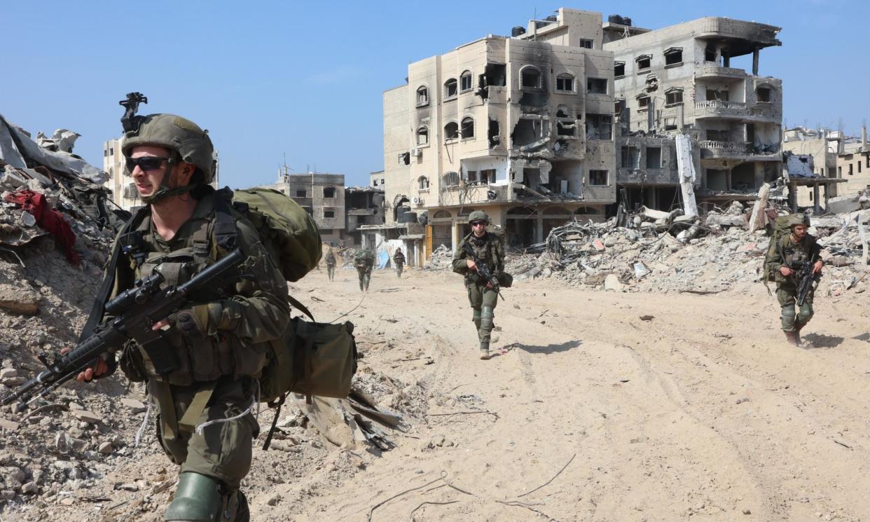 <span>Israeli troops in the southern Gaza Strip. Calls for an immediate unconditional ceasefire have so far been rejected by national governments.</span><span>Photograph: Xinhua/Rex/Shutterstock</span>