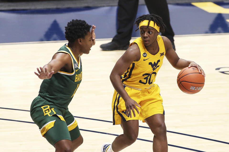 West Virginia guard Madisen Smith, right, is defended by Baylor guard Moon Ursin during the first half of an NCAA college basketball game Thursday, Dec. 10, 2020, in Morgantown, W.Va. (AP Photo/Kathleen Batten)