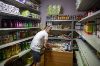 Igor Loparic prepares packages of aid for people in need for help in Pula, Croatia, Tuesday, May 26, 2020. The "Our Dream Their Smile" group has helped people in the tourism-dependent area in the Adriatic survive as the outbreak closed down borders, shutting down hotels, restaurants and other businesses that normally thrive in virus-free times. (AP Photo/Darko Bandic)