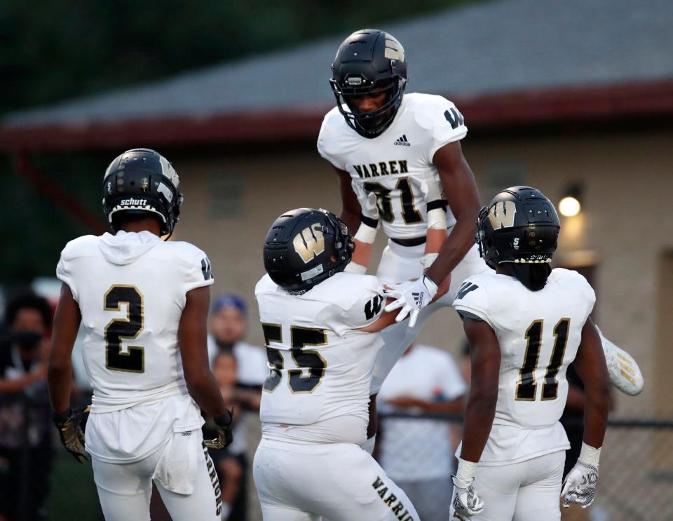 Warren Central's Joseph Walker Jr. (81) celebrates with his teammates after scoring a touchdown during the first half of the game Friday, Sept. 10, 2021, at Lawrence Central High School. The Warren Central High School Warriors beat the Lawrence Central Bears 48-13.