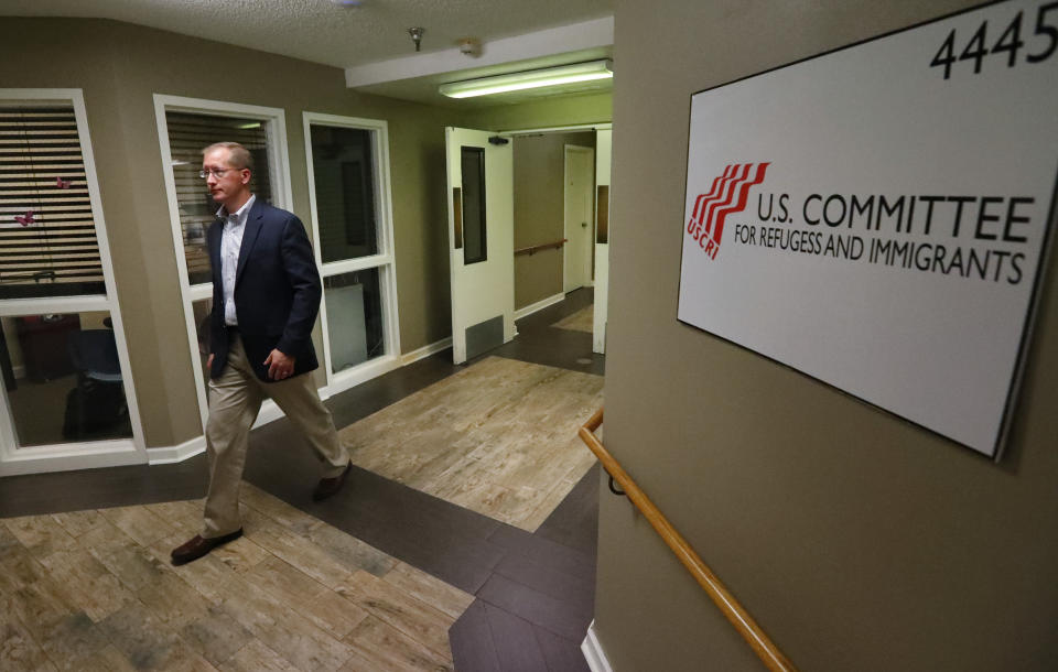 In this Tuesday, Sept. 24, 2019 photo, Jonathan Hayes, director of the Department of Health and Human Service’s Office of Refugee Resettlement, walks through the halls of a shelter for migrant teenage girls during a tour, in Lake Worth, Fla. (AP Photo/Wilfredo Lee)