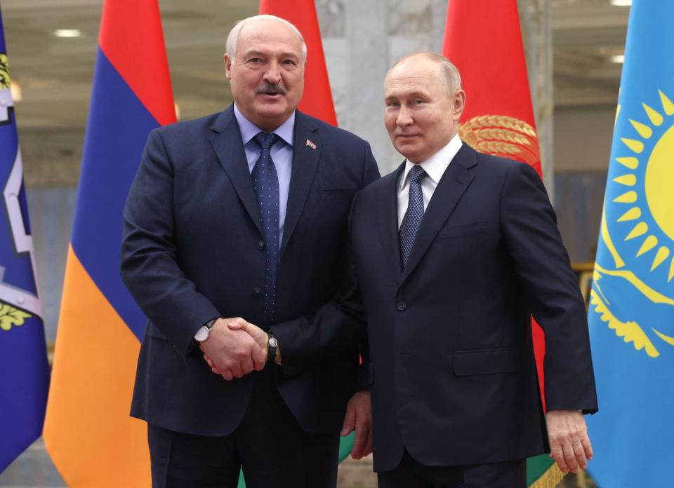 This pool photograph distributed by Russian state agency Sputnik shows Belarusian President Alexander Lukashenko greeting Russia's President Vladimir Putin prior to a meeting of leaders of the Collective Security Treaty Organisation (CSTO), a Russia-led security alliance comprising six post-Soviet states, in the Belarusian capital Minsk on November 23, 2023.  