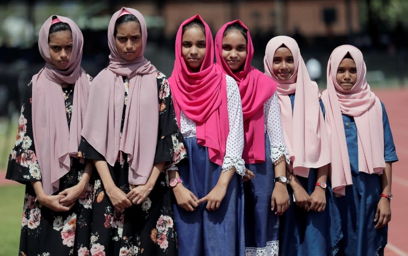 Hamna, Shahna (12), Umaira, Umaima (12) and Radha, Rana (12) pose for photographs during an event to attempt to break the world record for the biggest gathering of twins in Colombo
