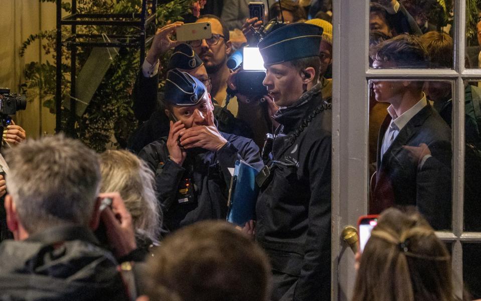 Belgian police enter the conference venue on Tuesday