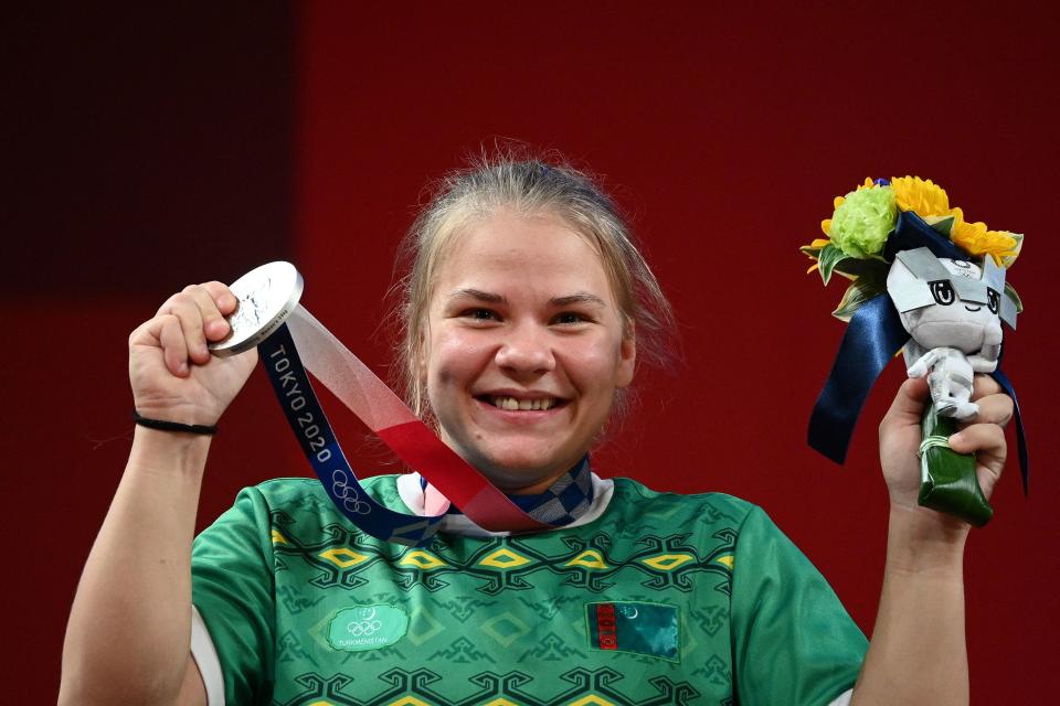 Silver medallist Turkmenistan's Polina Guryeva stands on the podium for the victory ceremony.