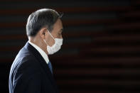 Former Chief Cabinet Secretary Yoshihide Suga walks at the prime minister's office after a cabinet meeting Wednesday, Sept. 16, 2020, in Tokyo. Prime Minister Shinzo Abe and his Cabinet resigned, clearing the way for his successor Suga to take over after parliamentary confirmation later in the day. (AP Photo/Eugene Hoshiko)