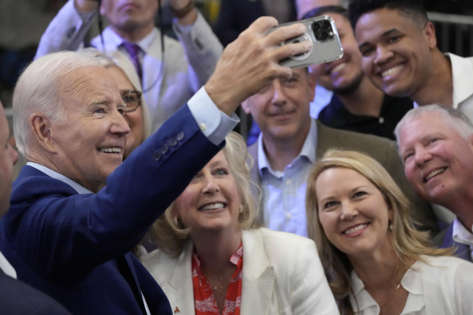President Joe Biden takes a selfie with supporters in the audience after speaking at the Arcosa Wind Towers, Wednesday, Aug. 9, 2023, in Belen, N.M. (AP Photo/Alex Brandon)