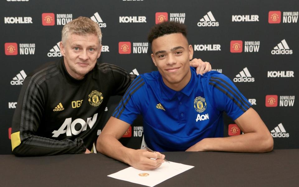 Mason Greenwood of Manchester United poses with Manager Ole Gunnar Solskjaer after signing a new contract - Getty Images