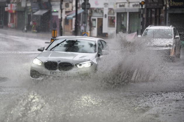 LONDON: A car negotiates a flooded section of road, as torrential rain and thunderstorms hit the country. (Photo: Leon Neal via Getty Images)