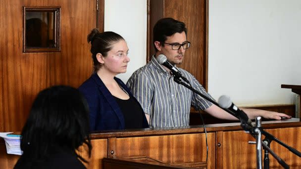 PHOTO: American couple Nicholas Spencer and Mackenzie Leigh Mathias Spencer, both 32, stand in the dock at Buganda road court, where they were charged with torturing a 10-year-old, in Kampala, Uganda, on Dec. 14, 2022. (Abubaker Lubowa/Reuters)