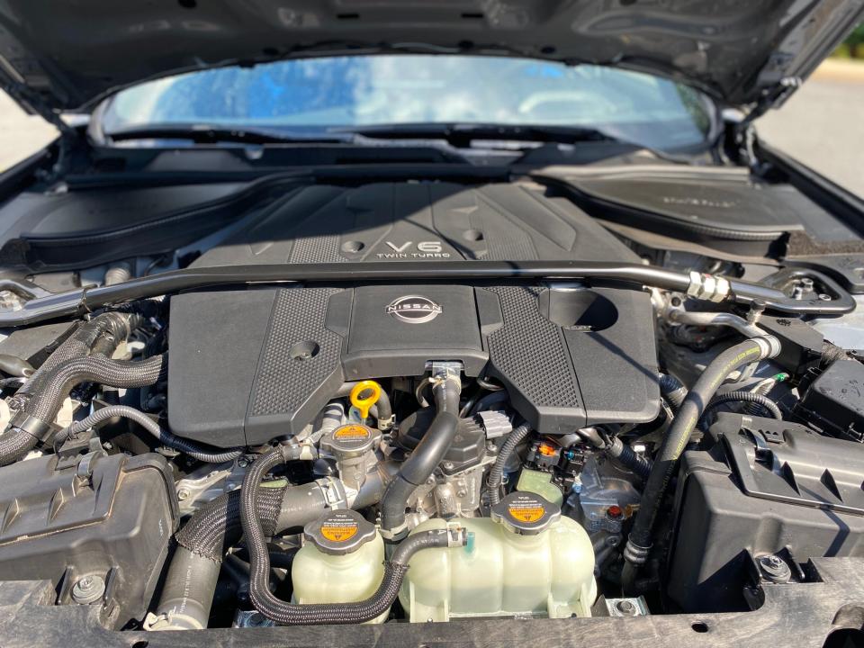 The engine compartment of a 2024 Nissan Z sports car with a 3.0 liter, twin-turbocharged V6 engine.